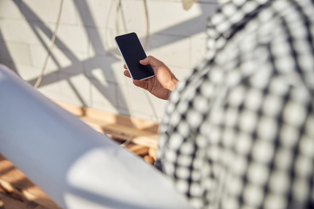 man in a checked shirt using his smartphone and ca 2026 01 05 23 03 10 utc