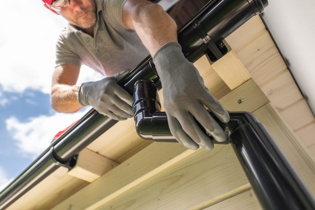 worker installing gutter system on roof 2026 01 09 00 20 24 utc 1